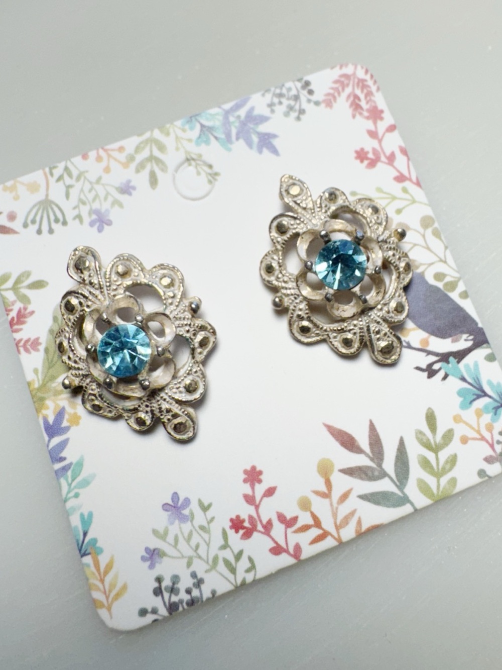 Antique Style Blue Rhinestone Scrolled Earrings in Silver Tone Post Back
